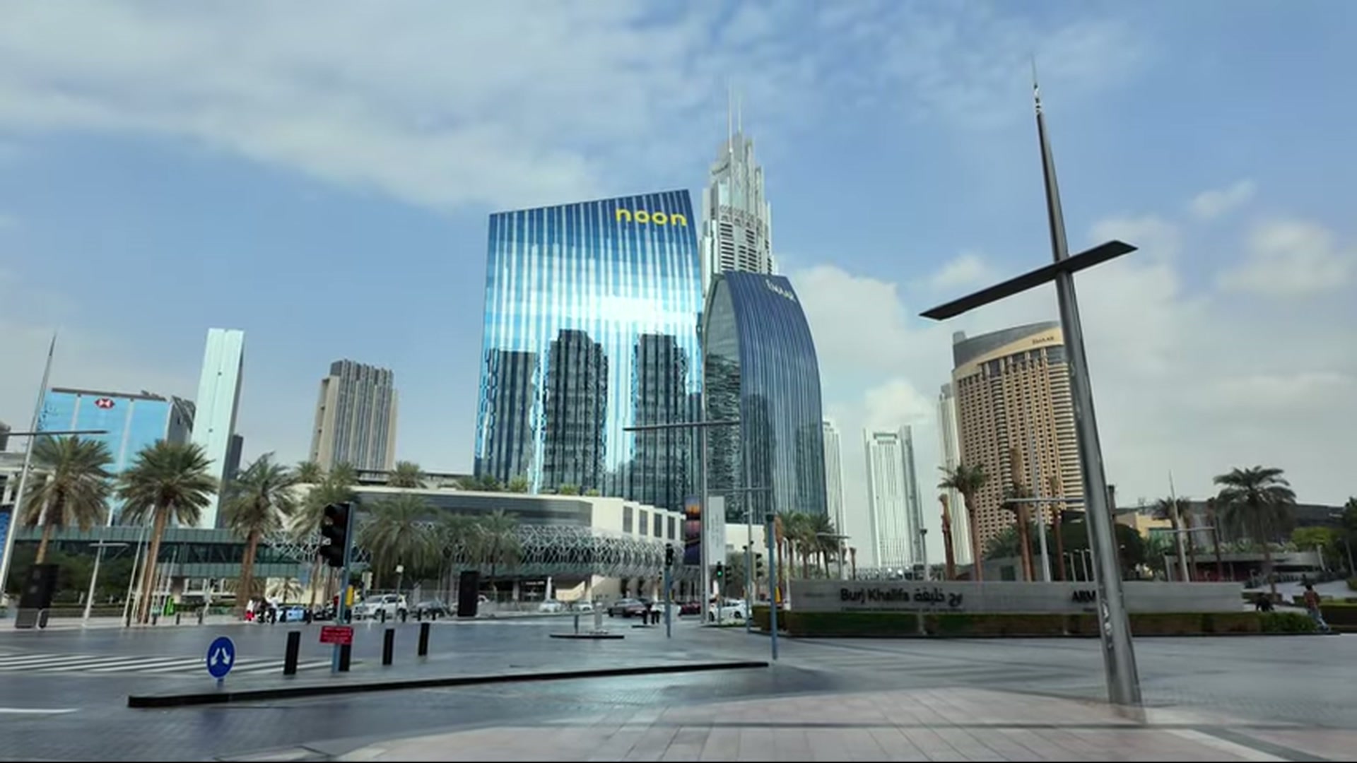 Open plaza facing sleek mirrored towers in Downtown Dubai